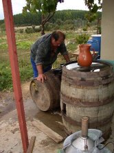 Nicanor lavando una cuba en el exterior de su bodega.